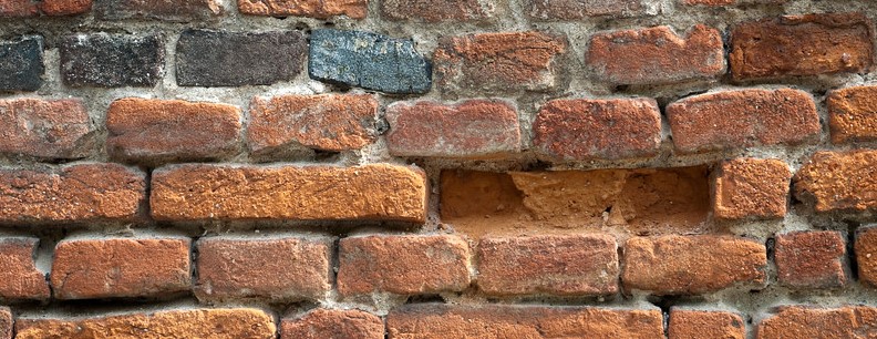 A wall with a brick missing goes with the poem The Unbuilder by writer Olivia Payne of London.