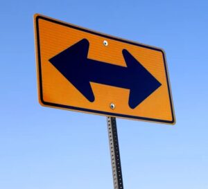 A highway sign pointing in opposite directions.
